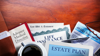 Estate planning documents and a cup of coffee set on a table.
