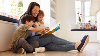 parent with small children reading
