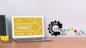 The word donate on a yellow laptop screen
