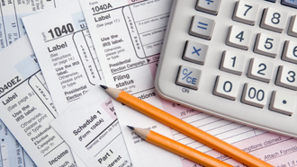 tax documents, two pencils, and a calculator